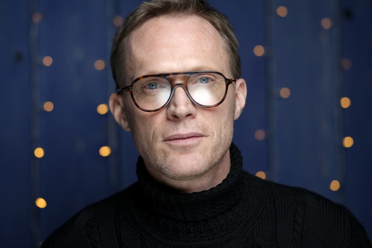 Paul Bettany posing while wearing a black turtle neck.