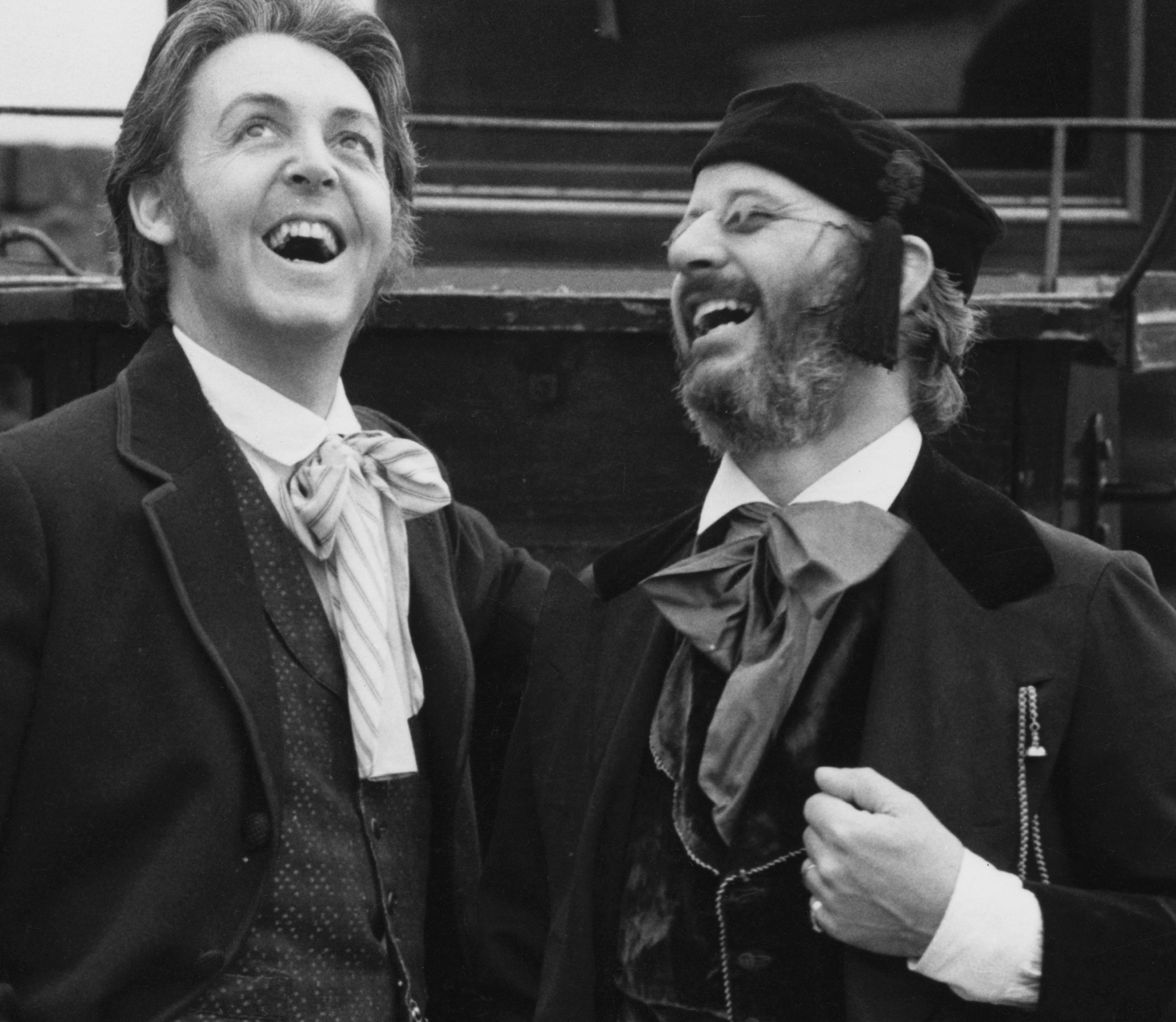 The Beatles' Paul McCartney and Ringo Starr in front of a carriage