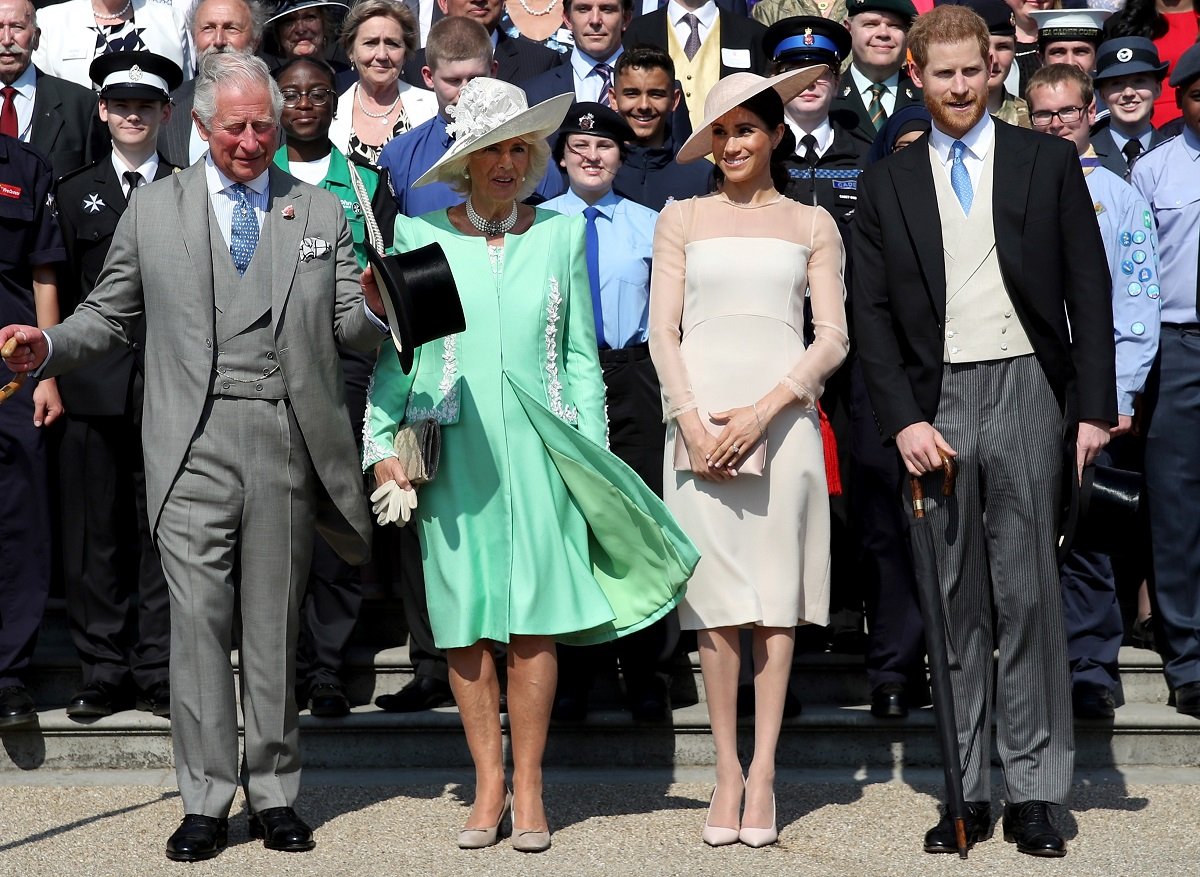 Prince Harry, Camilla Parker Bowles, Meghan Markle, and Prince Charles who recently opened Parliament, pose for a photo as they attend The Prince of Wales' 70th Birthday Patronage Celebration