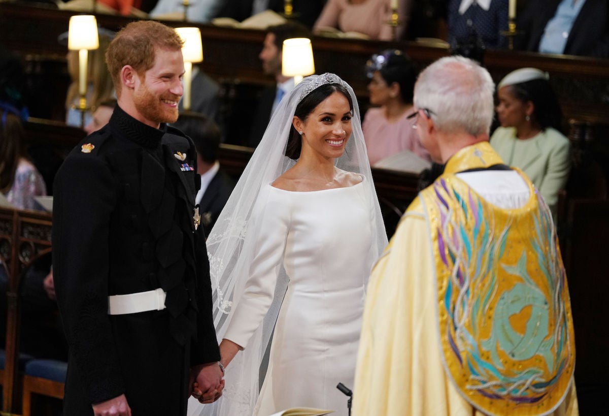 Prince Harry and Meghan Markle, who a body language expert says didn't exhibit many 'intimacy and closeness signals,' smile during their royal wedding