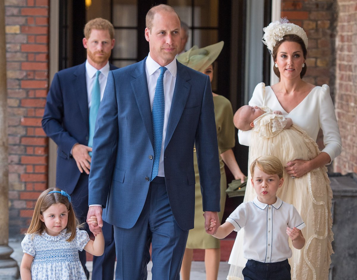 Prince Harry and Meghan Markle walk behind Prince William, Kate Middleton, Prince Louis, Prince George, and Princess Charlotte