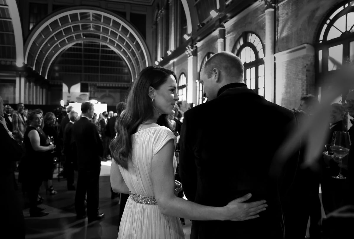 Kate Middleton gently puts her arm around Prince William in a photo taken from behind them