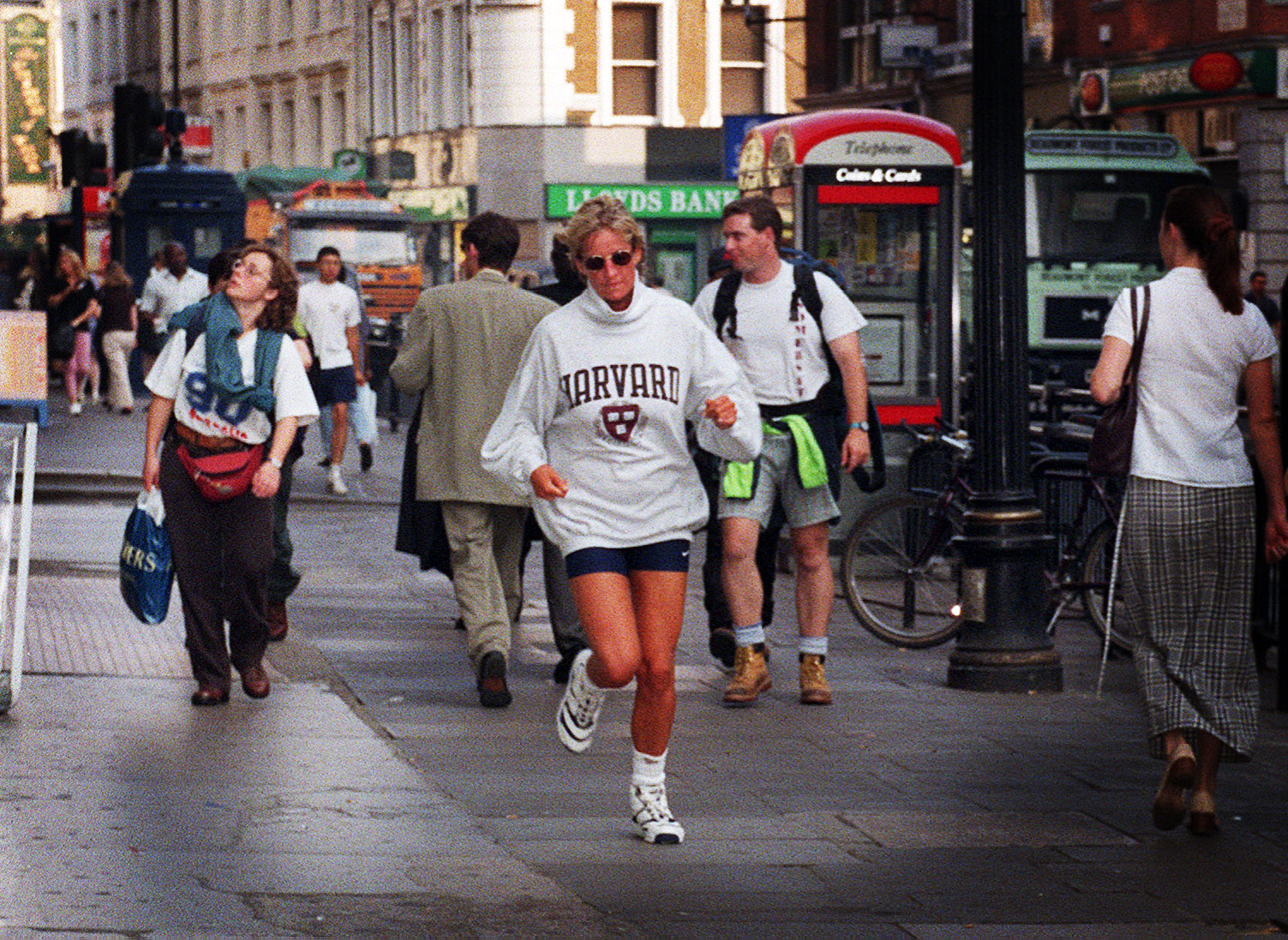 Princess Diana goes unnoticed as she jogs to her car after exiting the gym