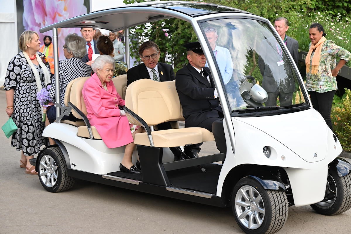 Queen Elizabeth II, who toured the Chelsea Flower Show in a golf cart, tours the exhibits sitting in the backseat 