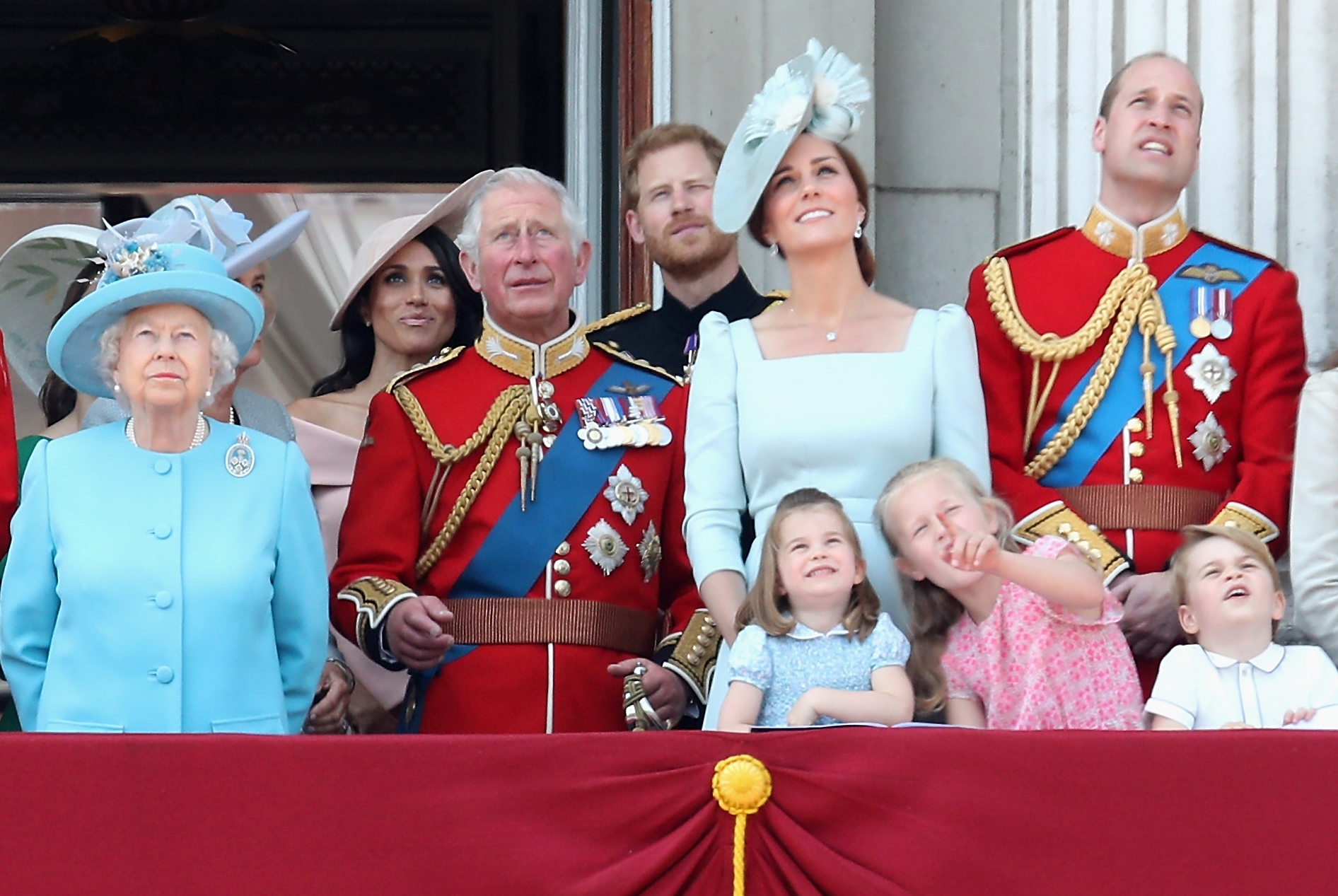 Queen Elizabeth standing on the balcony with some a couple of her great-granddaughters and great-grandson Prince George