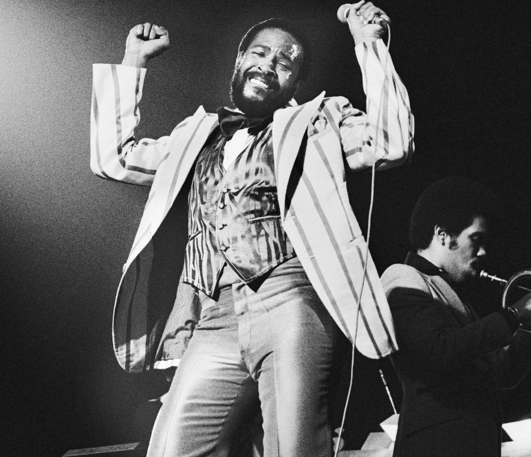 Marvin Gaye singing songs with a microphone
