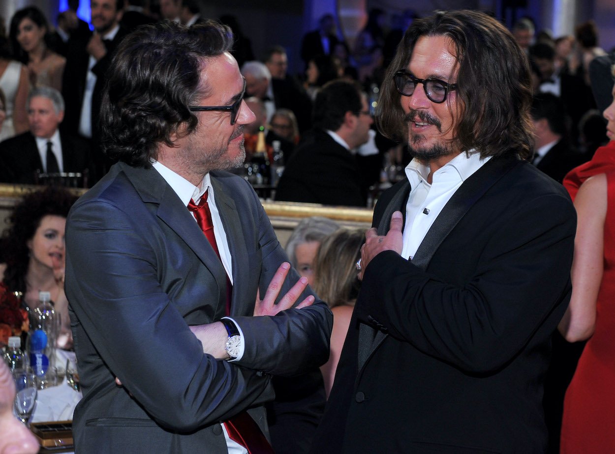 Robert Downey Jr. and Johnny Depp at the 2011 Golden Globes. Downey wants to add Depp to the 'Sherlock Holmes 3' cast, but it's unlikely to happen.