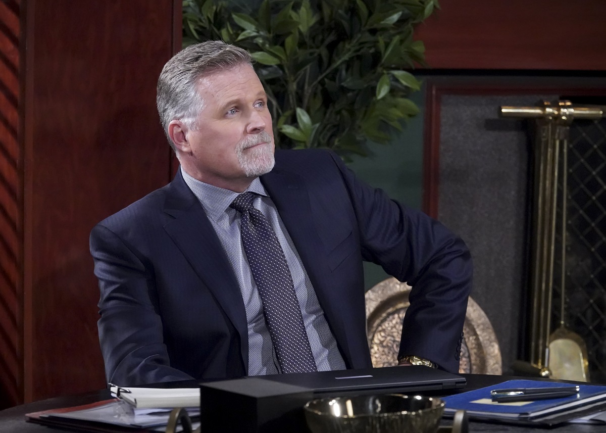 'The Young and the Restless' actor Robert Newman wearing a navy blue suit and sitting in the Newman Enterprises office.