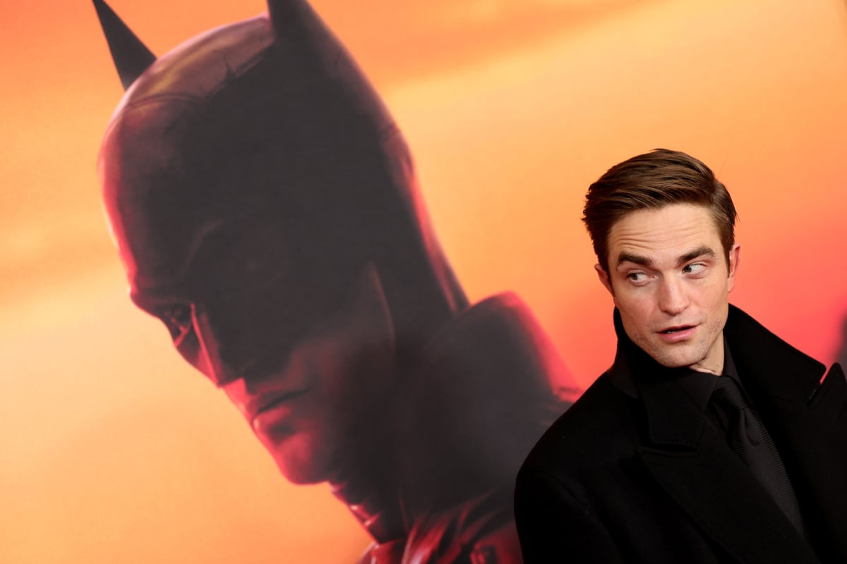 Robert Pattinson – overshadowed by an image of Batman -- attends "The Batman" World Premiere on March 01, 2022 in New York City