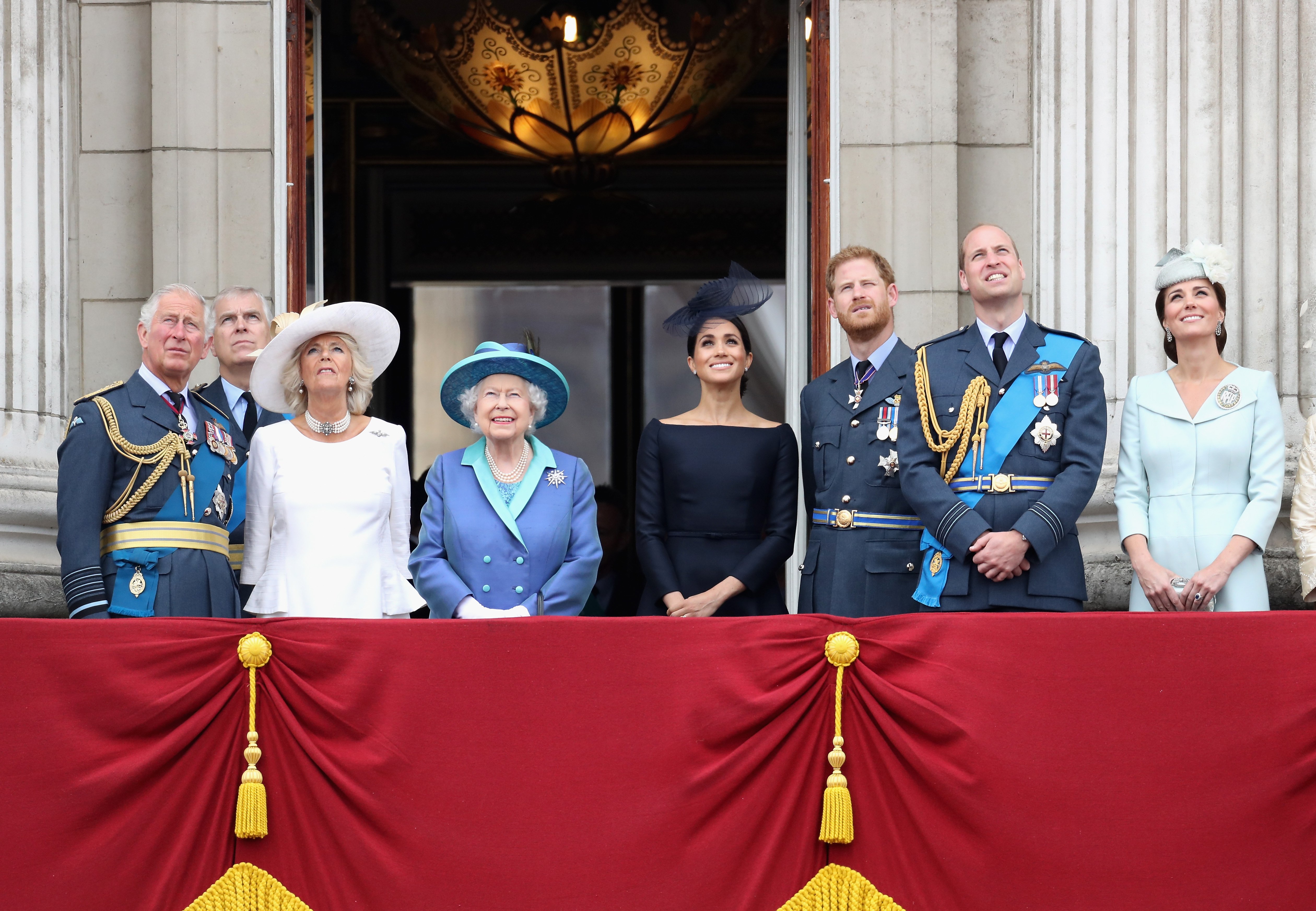 Prince Charles, Prince of Wales, Prince Andrew, Duke of York, Camilla, Duchess of Cornwall, Queen Elizabeth II, Meghan, Duchess of Sussex, Prince Harry, Duke of Sussex, Prince William, Duke of Cambridge and Catherine, Duchess of Cambridge watch the RAF flypast on the balcony of Buckingham Palace
