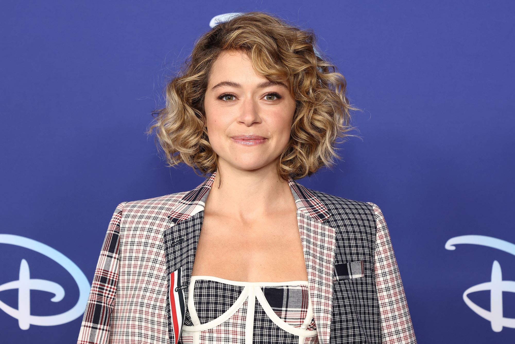 Tatiana Maslany, who stars in the MCU's 'She-Hulk: Attorney at Law,' wears a black, red, and white plaid suit jacket.