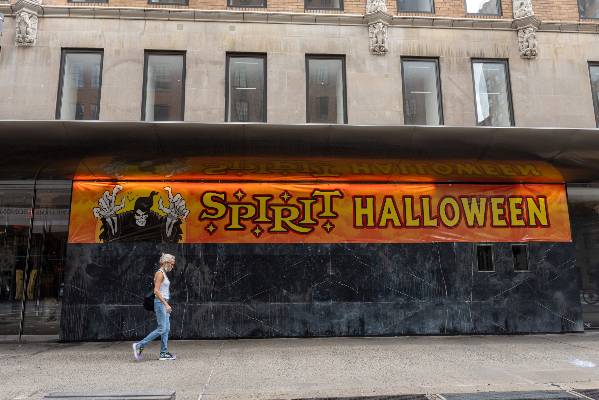 Spirit Halloween retail store, which inspired the 'Spirit Halloween' movie. A person passes in front of the temporary store sign.