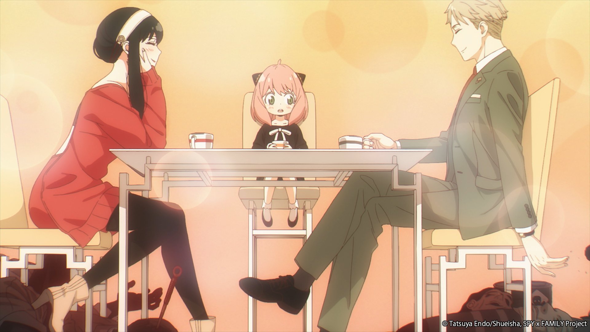 Yor, Anya, and Loid Forger drinking tea in 'Spy x Family.' Yor is leaning on the table, Anya is sitting between them, and Loid is smiling.