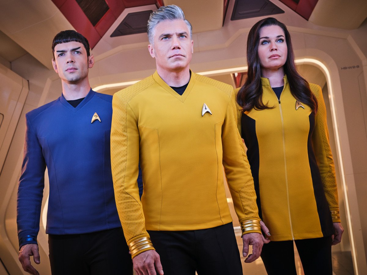 A promotional image from 'Star Trek: Strange New Worlds,' a canon series featuring characters Spock, Pike, and Number Two in their uniforms.