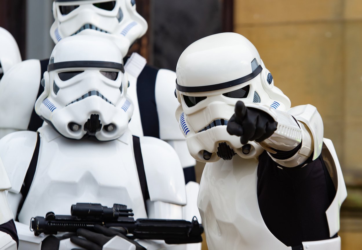 Two people in stormtrooper gear participate in a 'Star Wars' parade in Spain in November 2021, several months before and after the annual May 4th 'Star Wars' Day.