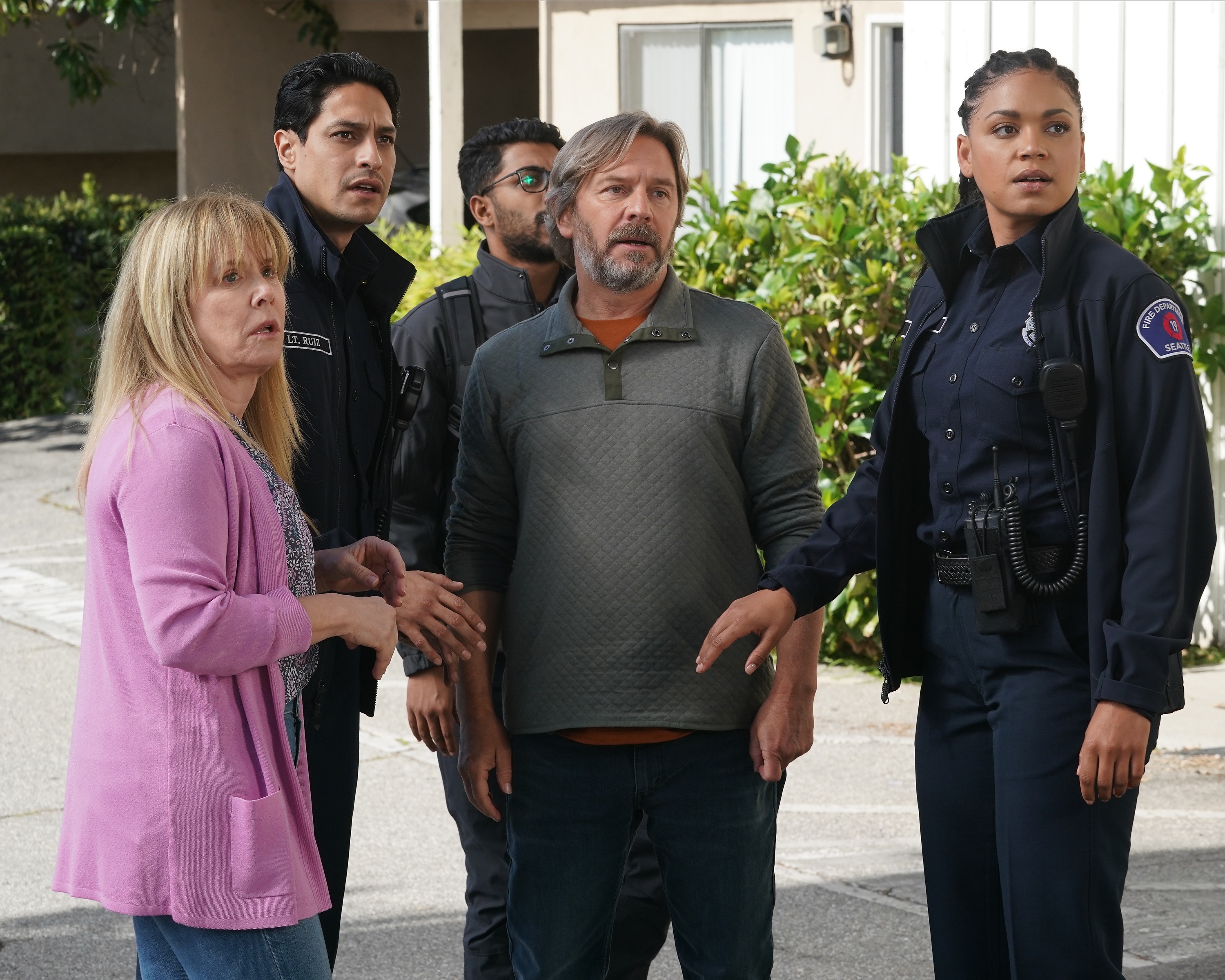 'Station 19' Season 5 Episode 17 guest stars Romy Rosemont and Ben Bode stand with cast members Carlos Miranda and Barrett Doss all looking shocked at the same thing