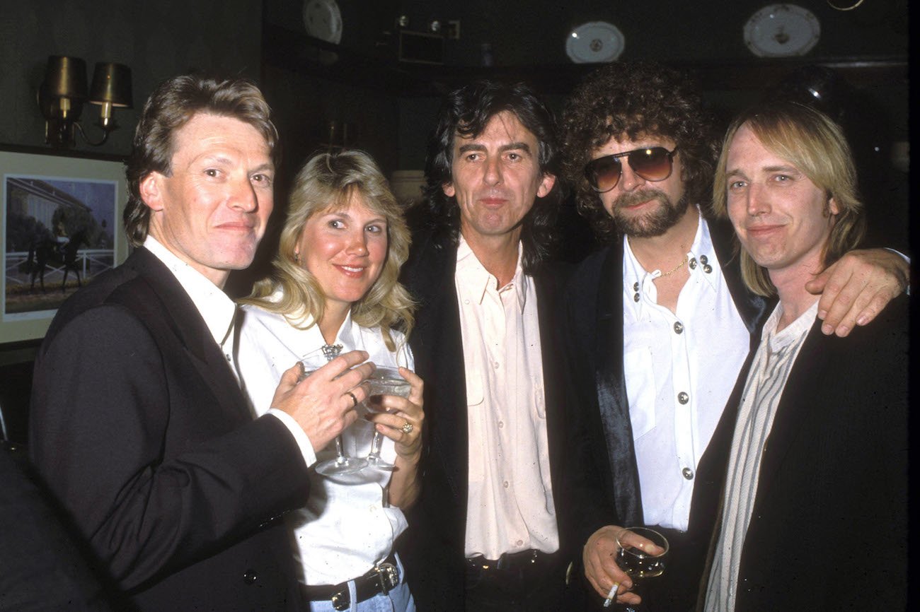 Steve Winwood and wife, George Harrison, Jeff Lynne, and Tom Petty having drinks at a party in 1992.