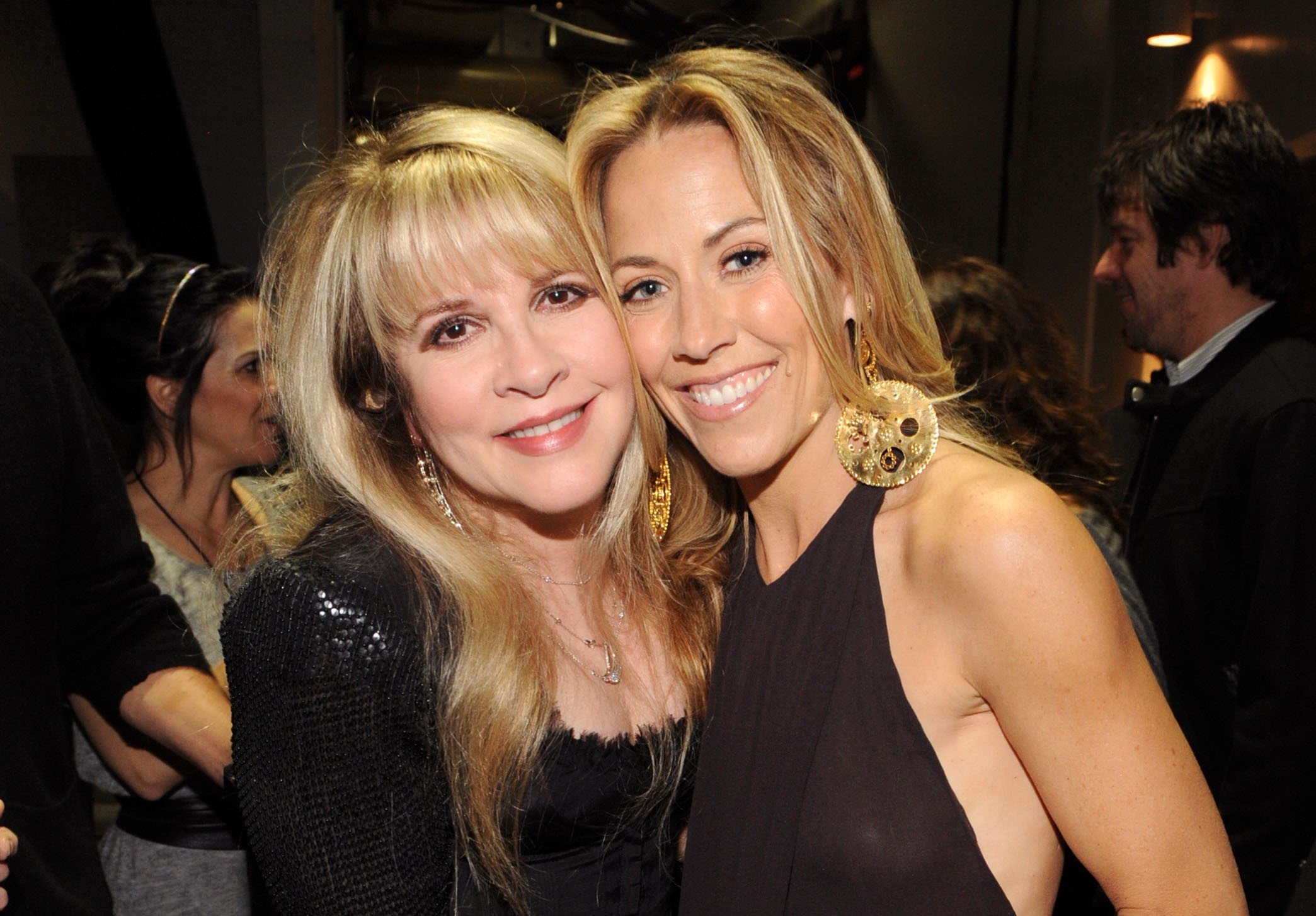 Stevie Nicks and Sheryl Crow both wear black and pose cheek to cheek.