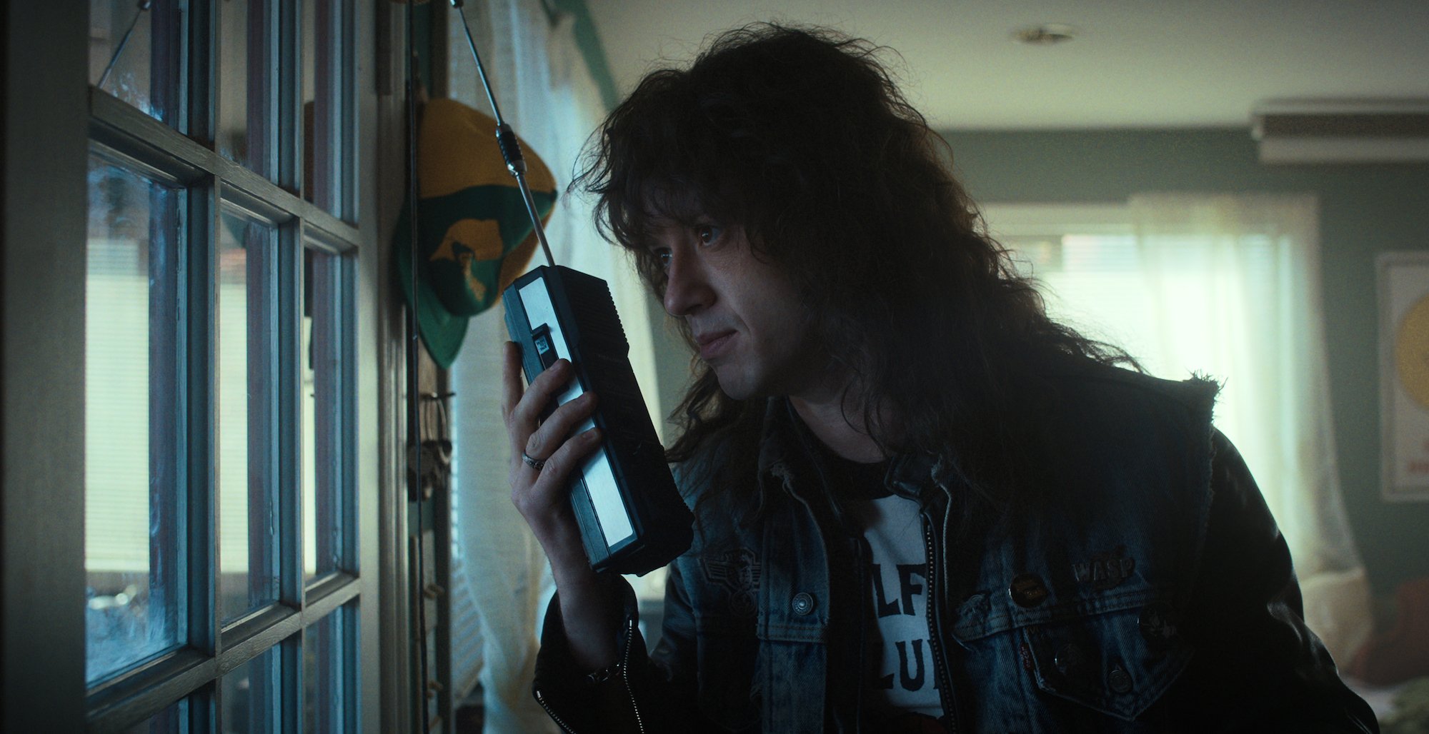 'Stranger Things 4' Episode 'The Dive' features Eddie, played by Joseph Quinn seen here holding a walkie talkie, asking Dustin and the rest of the group for help.