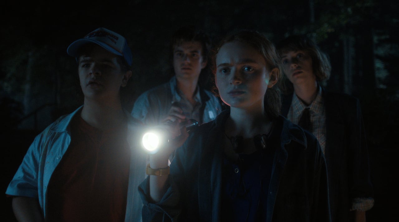 Dustin, Steve, Max, and Robin walk through the woods in 'Stranger Things' Season 4.