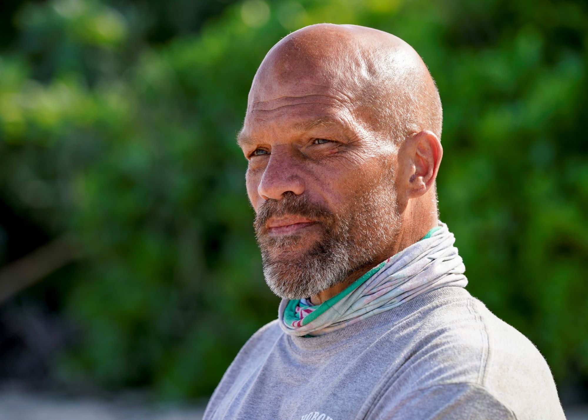 'Survivor' Season 42 castaway Mike Turner wears a gray shirt and his green buff around his neck.