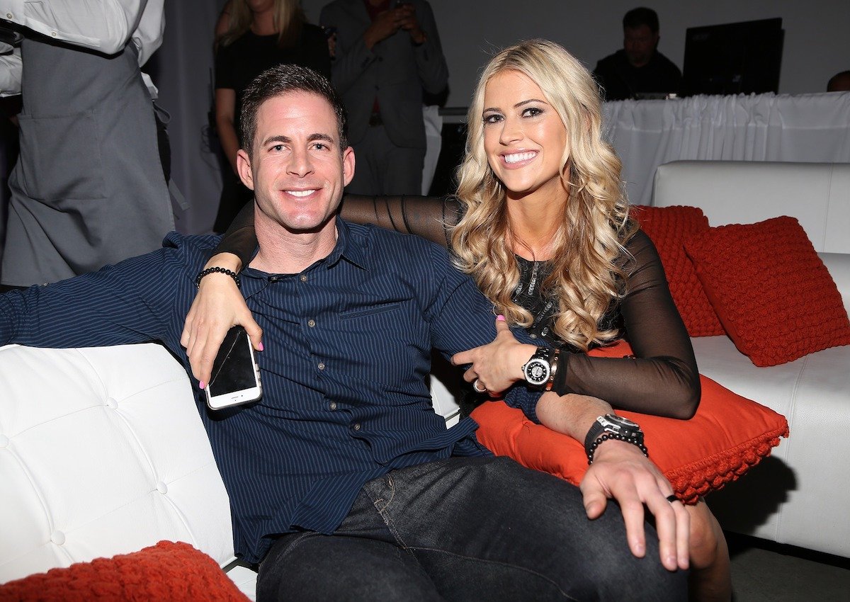 Tarek El Moussa and Christina Haack, who said their daughter Taylor announced she no longer needed therapy, smile as they sit together on a couch