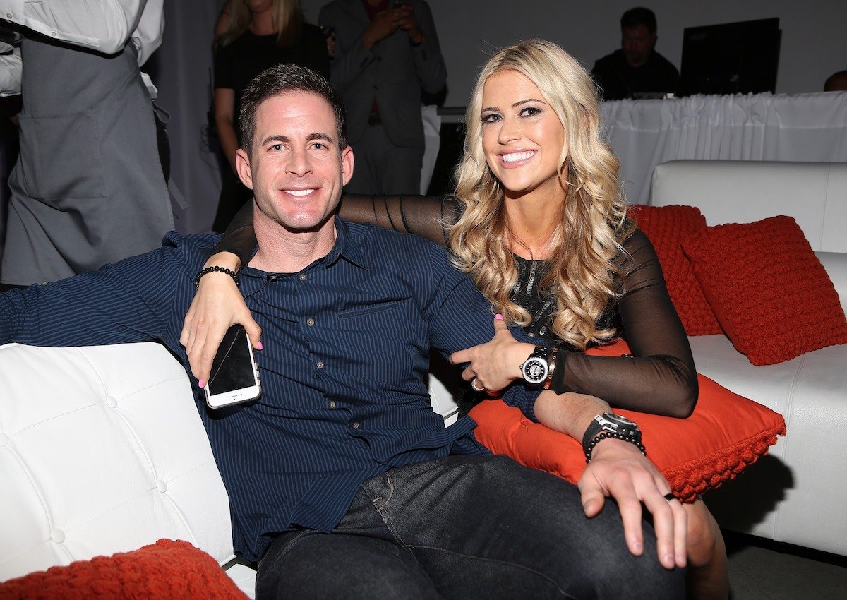 Tarek El Moussa and Christina Haack, who said their daughter Taylor has announced she no longer needs therapy, smile as they sit on a couch together
