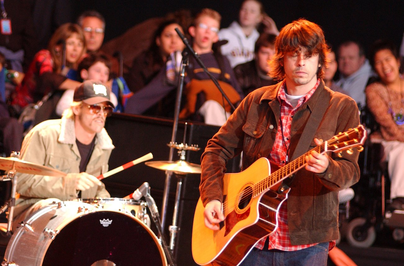 Taylor Hawkins and Dave Grohl performing during Neil Young's 16th Annual Bridge Benefit in 2002.