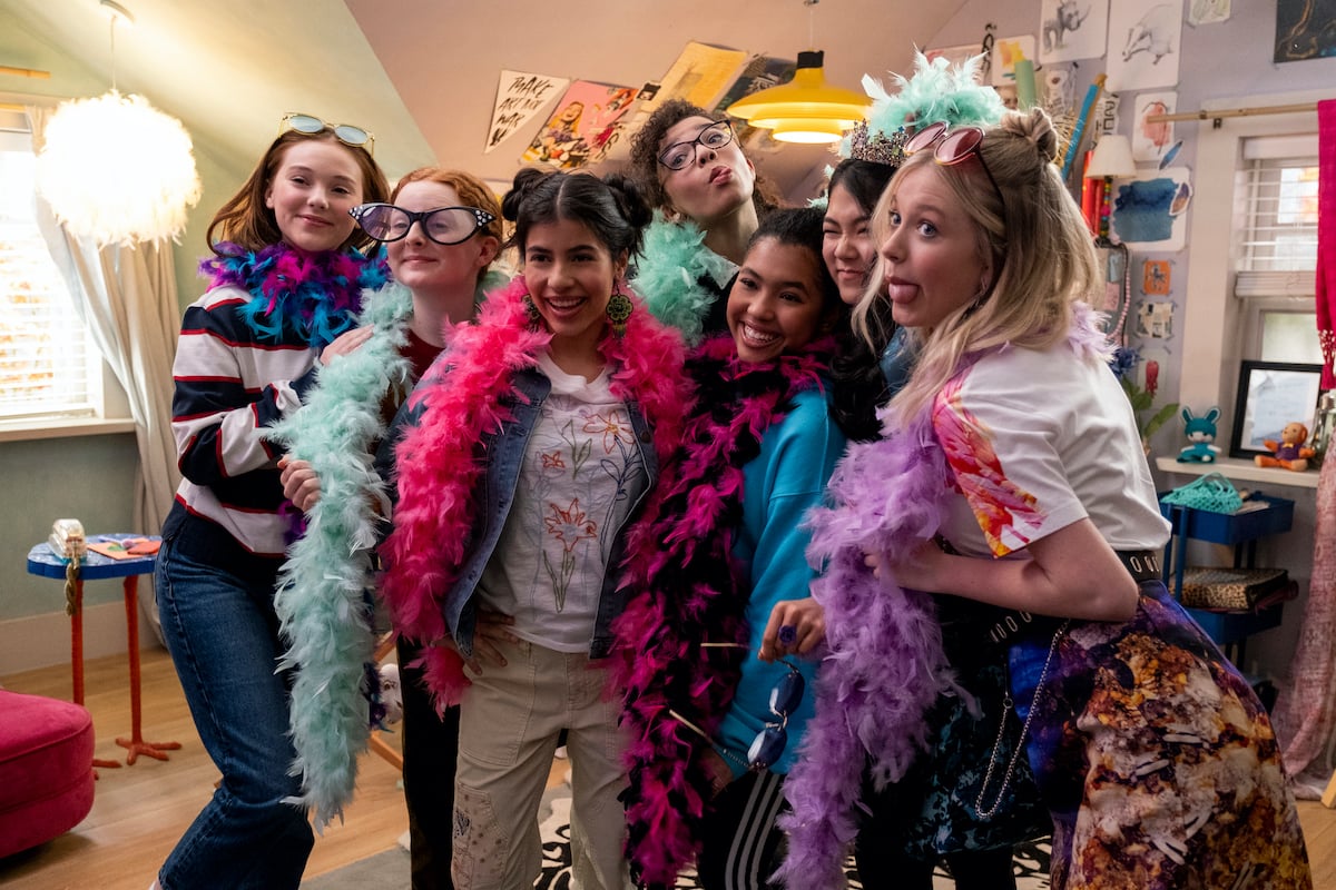 Group photo of the members of the The Baby-Sitters Club wearing feather boas from the canceled Netflix series 'The Baby-Sitters Club'