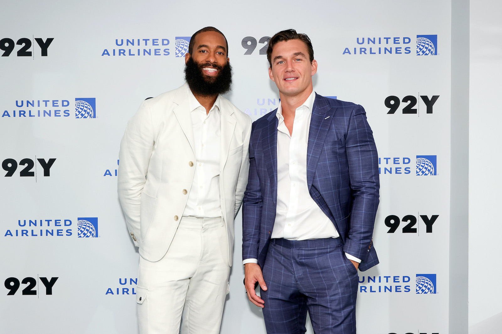Matt James and Tyler Cameron from 'The Bachelor' smile on the step and repeat at a recent event 