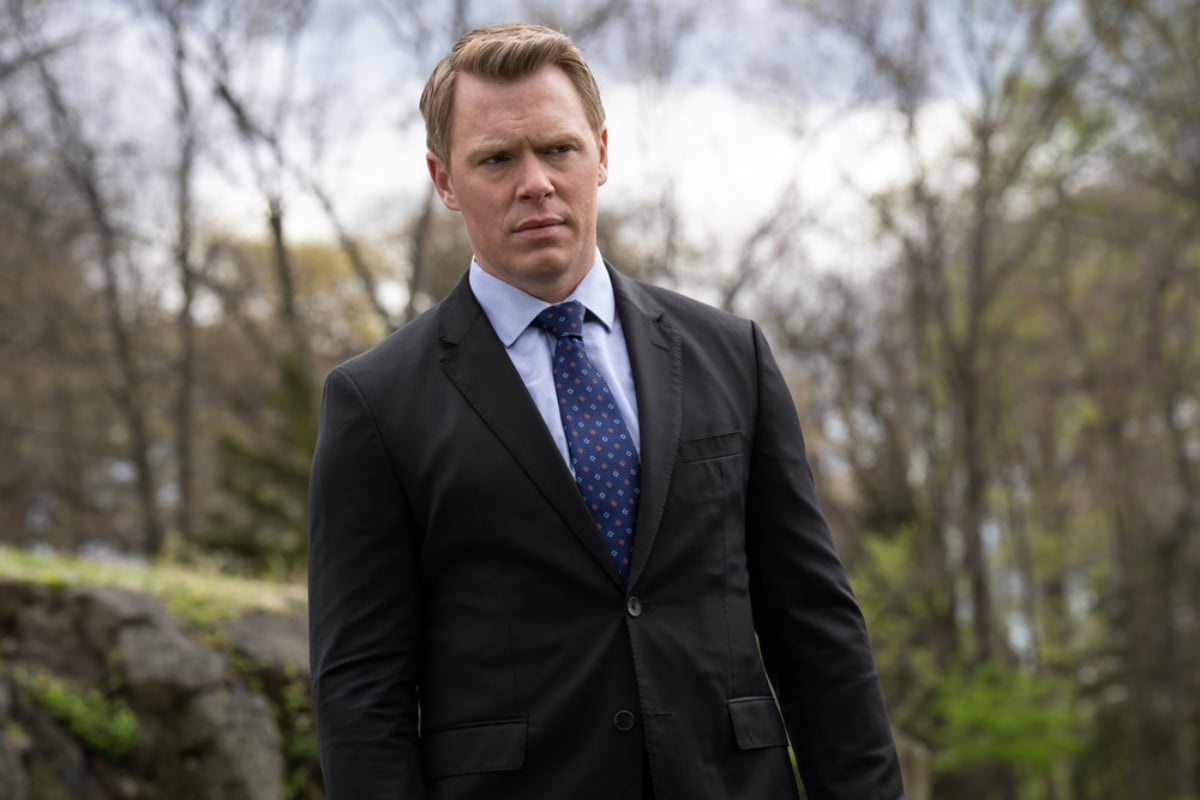 Diego Klattenhoff as Donald Ressler in The Blacklist Season 9 finale. Ressler stands outside wearing a suit. 