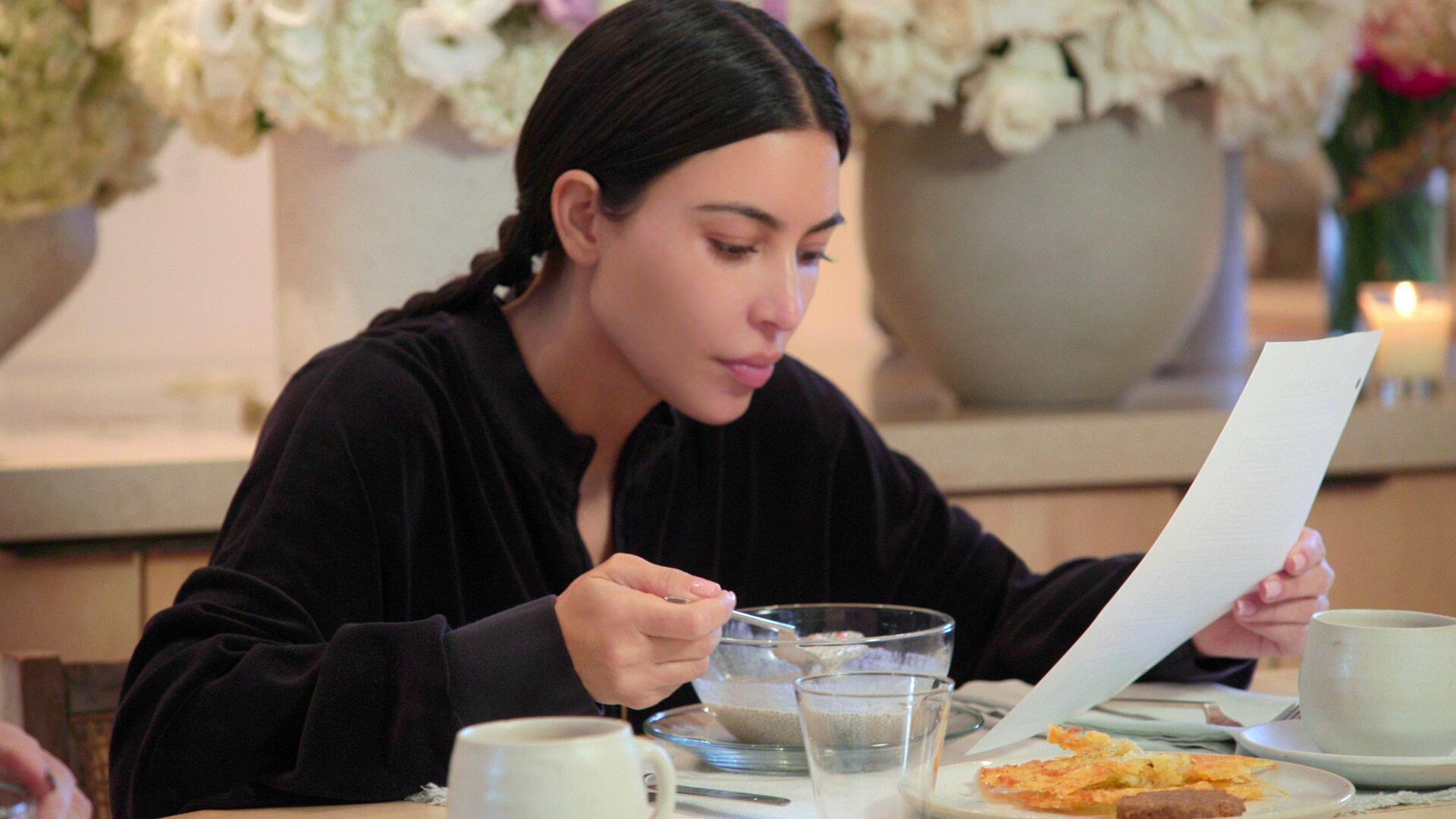 Kim Kardashian wears a black shirt and eats cereal as she prepares for the baby bar in 'The Kardashians' Episode 5 'Who is Kim K?'