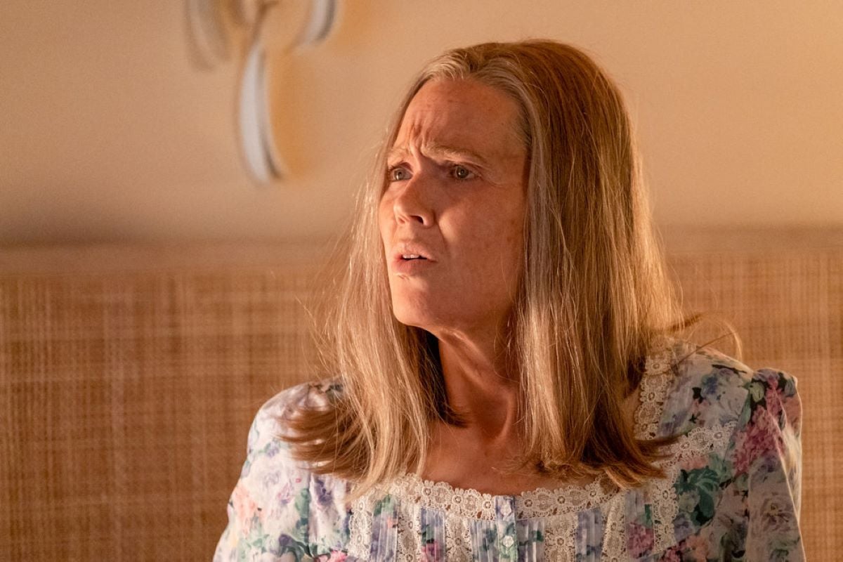 Mandy Moore, in character as Rebecca Pearson during a 'This Is Us' Season 6 flash-forward, wears a white, pink, green, and blue floral nightgown.