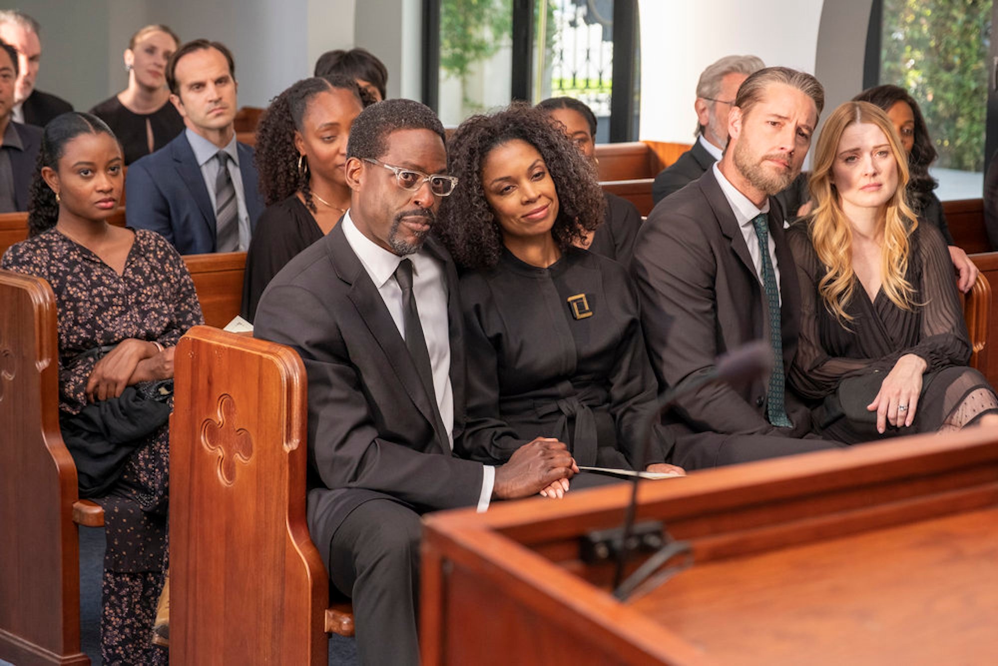 Annie, Tess, Randall, Kevin, and Sophie sitting together dressed in black at Rebecca's funeral in the 'This Is Us' Season 6 finale