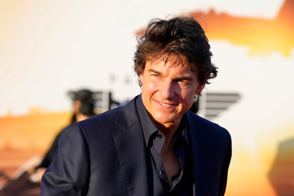 Tom Cruise smiling while wearing a suit.