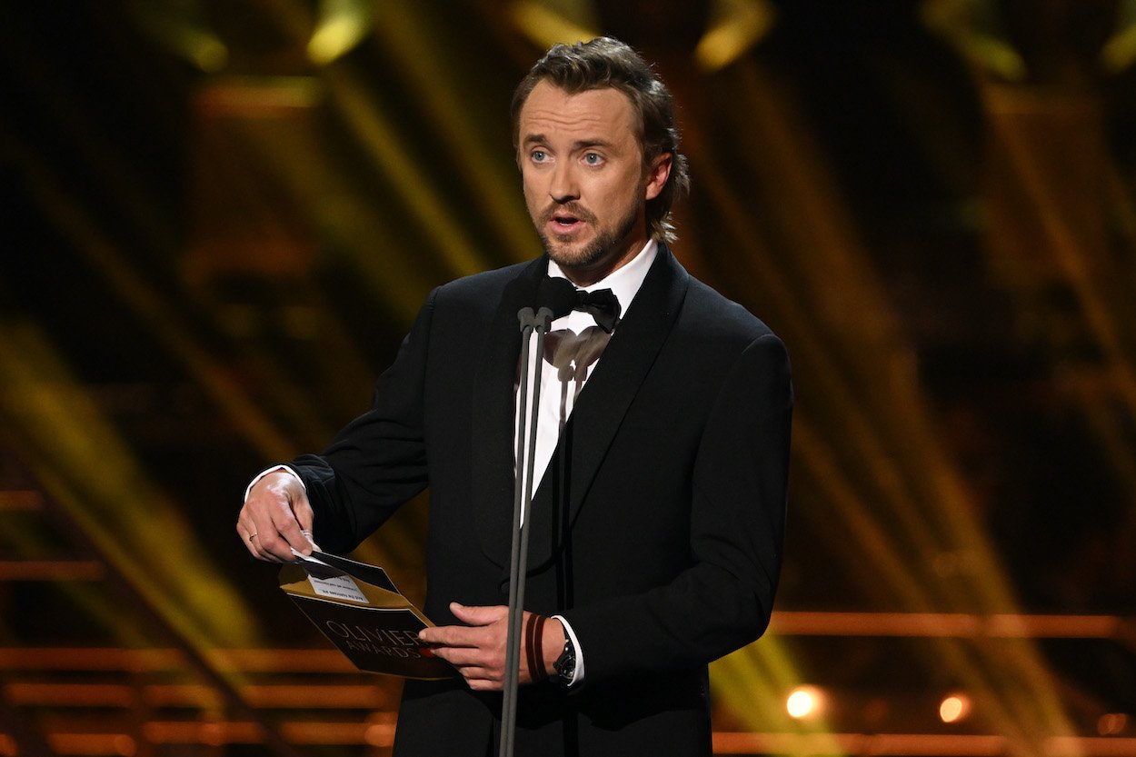 Tom Felton presents an award at the 2022 Olivier Awards