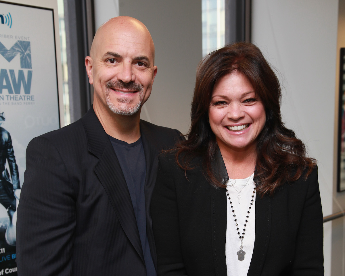 Tom Vitale and Valerie Bertinelli, who made a meal for her husband on 'Valerie's Home Cooking,' stand next to each other and smile