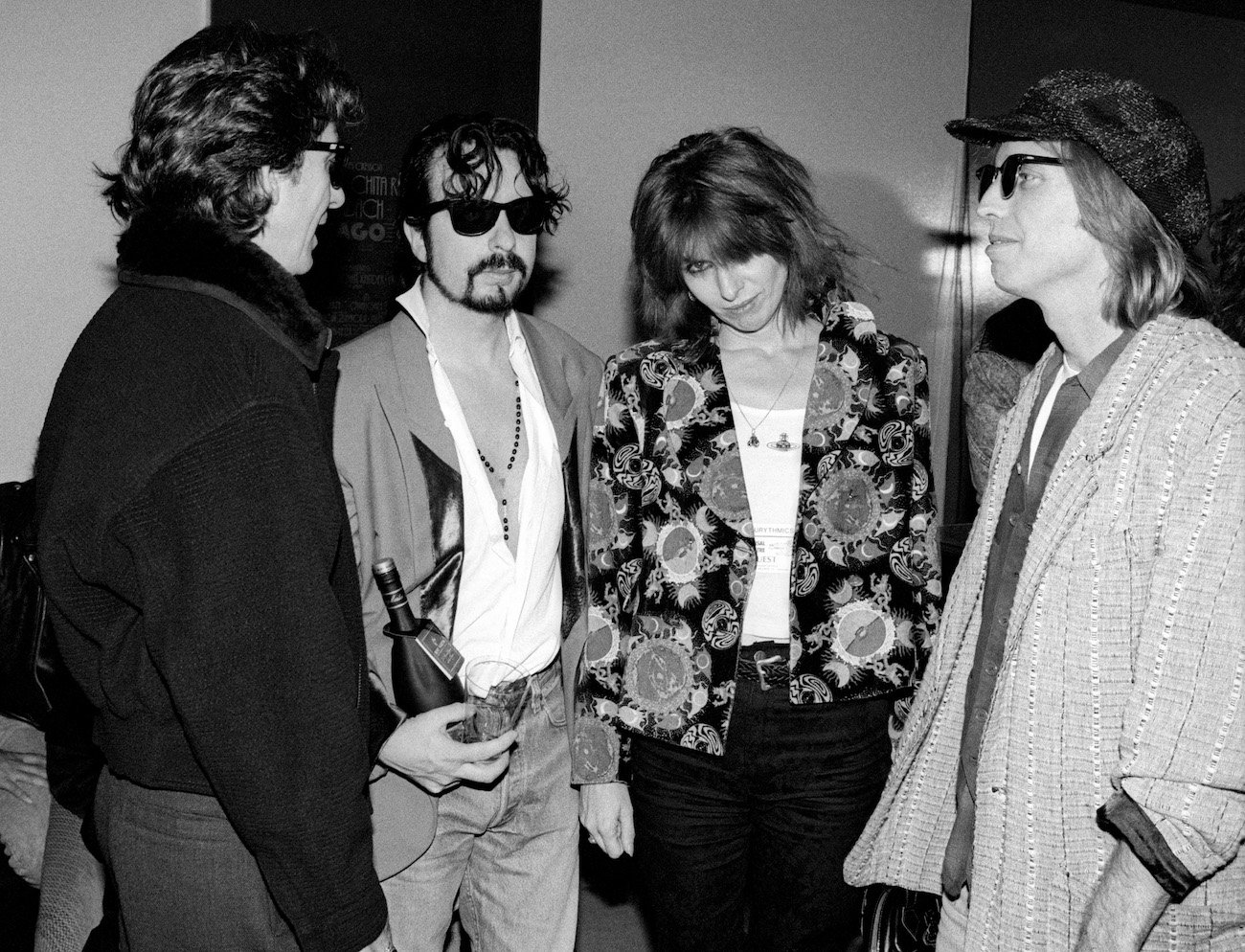Traveling Wilburys George Harrison and Tom Petty with Dave Stewart and Chrissie Hynde backstage in 1990.