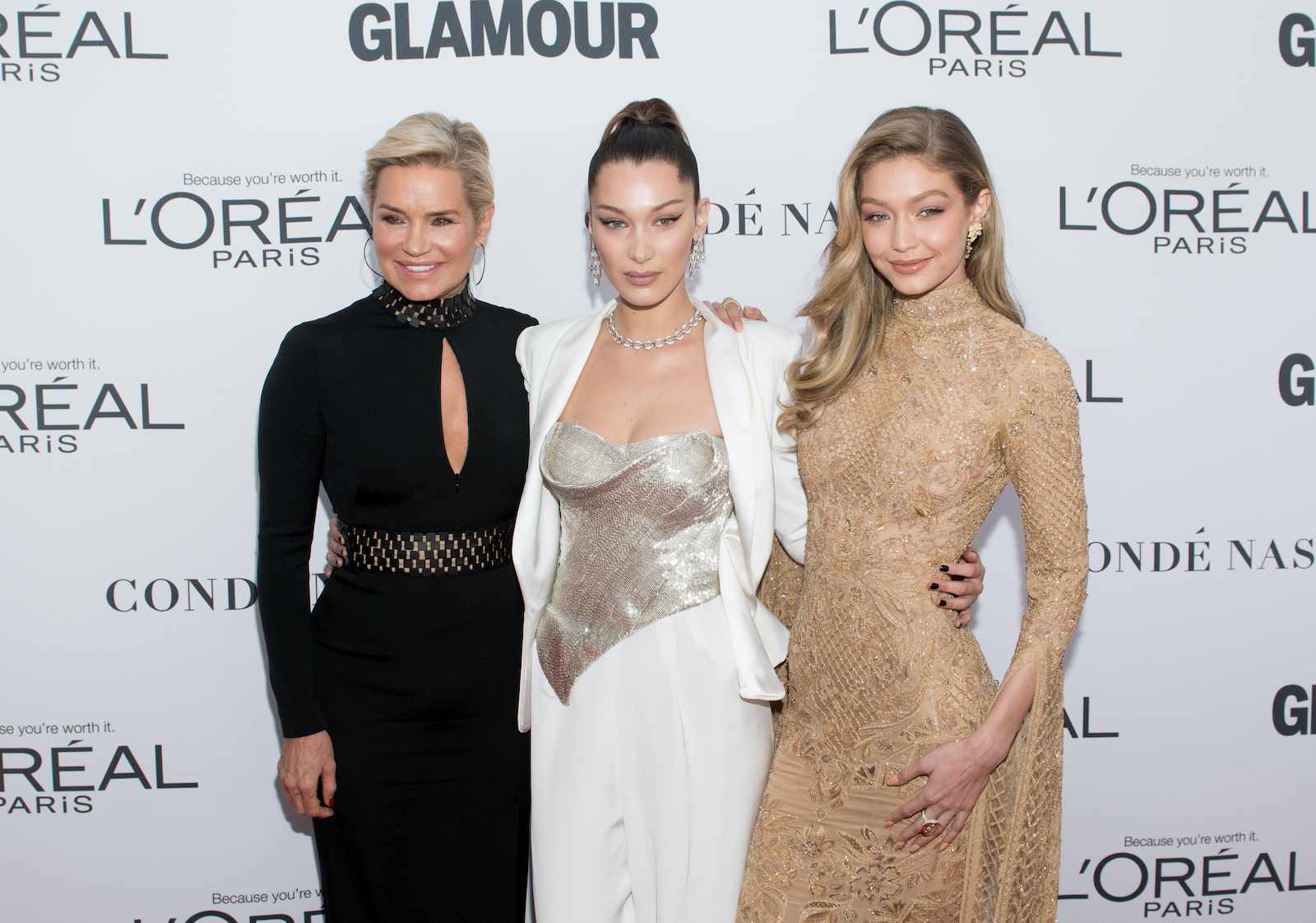 Yolanda Hadid, Bella Hadid, and Gigi Hadid smile for cameras during an awards ceremony 