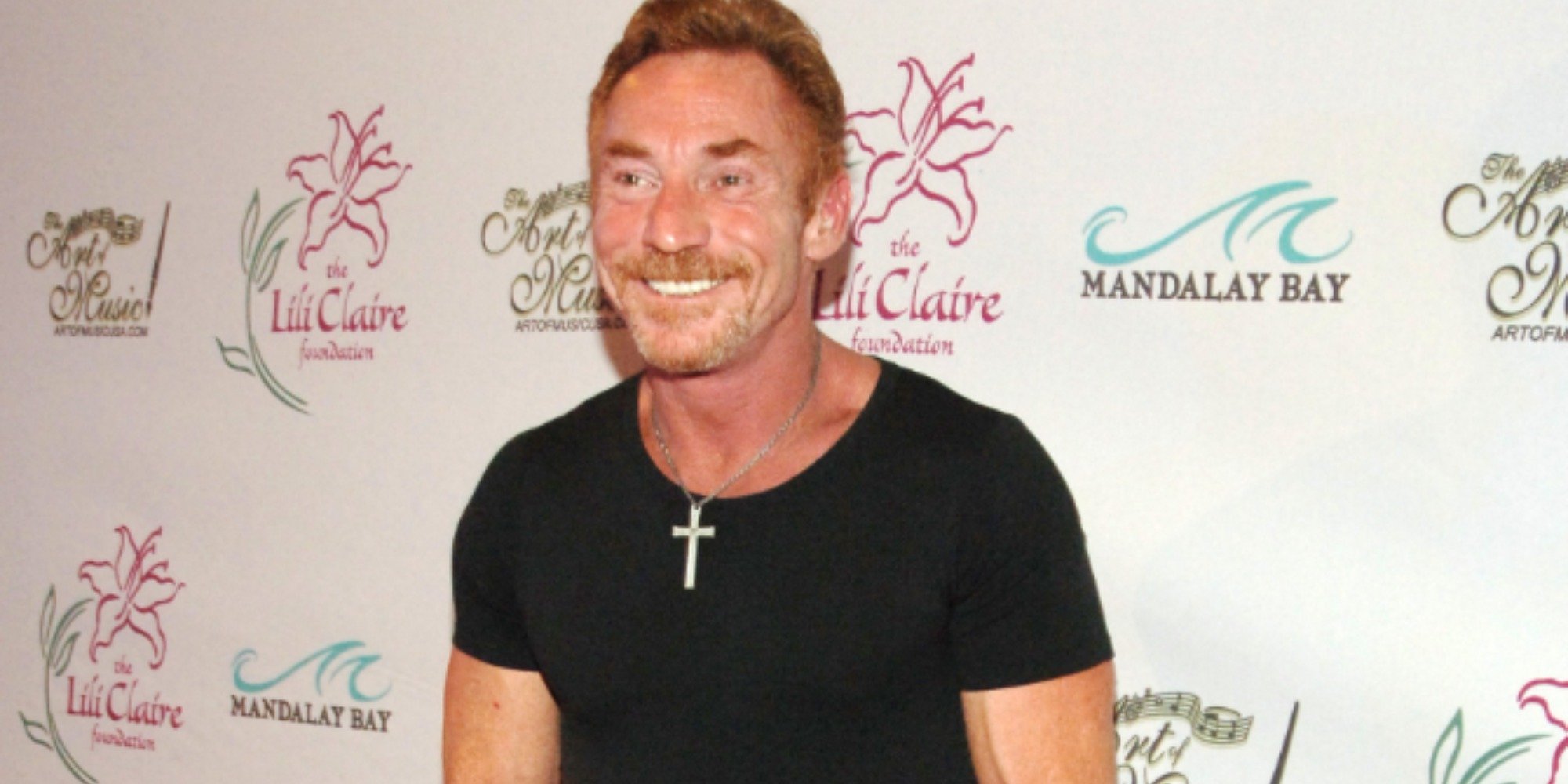 Danny Bonaduce, who recently announced his illness, smiling and wearing a black shirt on the red carpet at a press event in 2007.