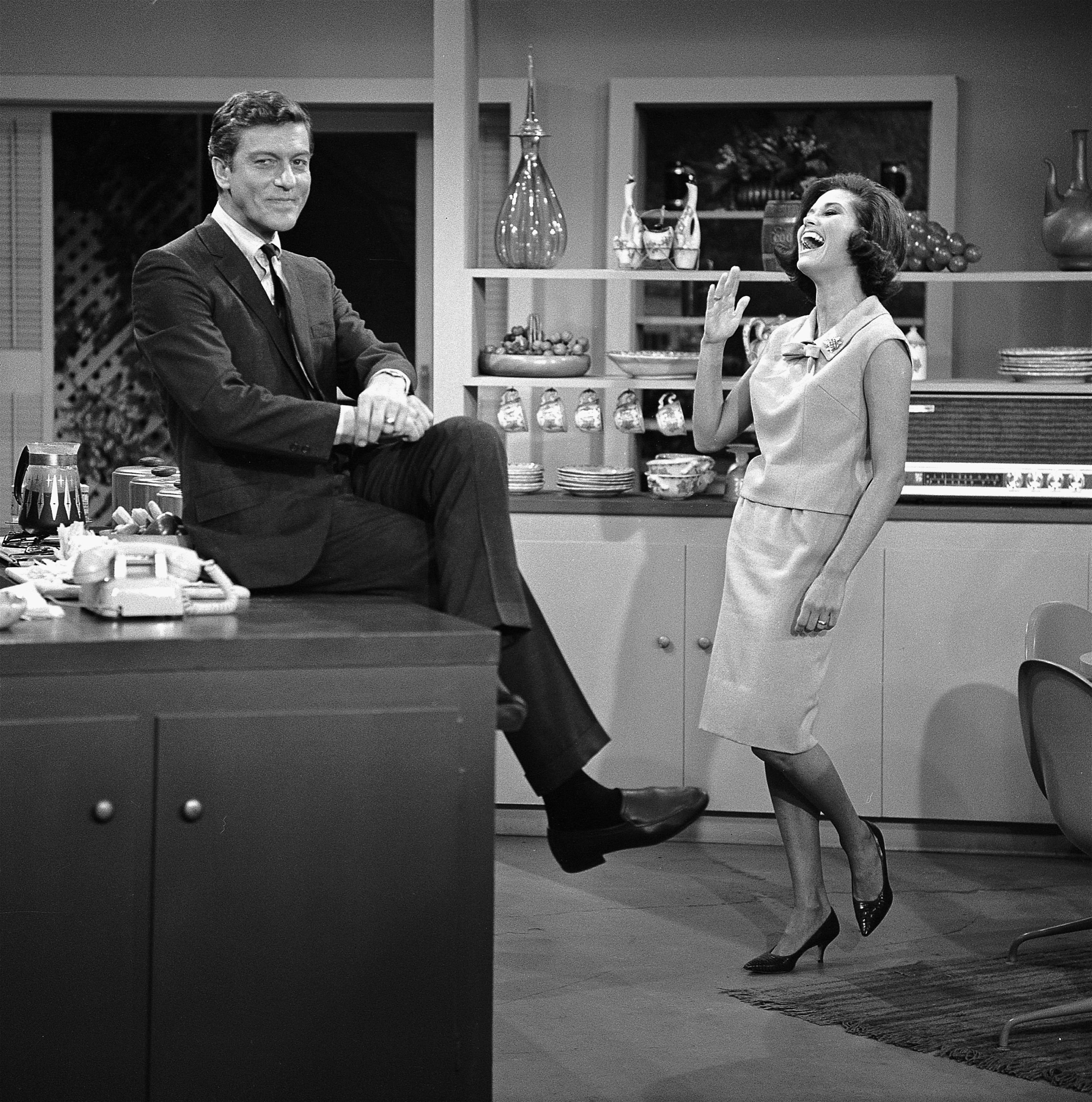 Dick Van Dyke and Mary Tyler Moore stand in their kitchen in 'The Dick Van Dyke Show'