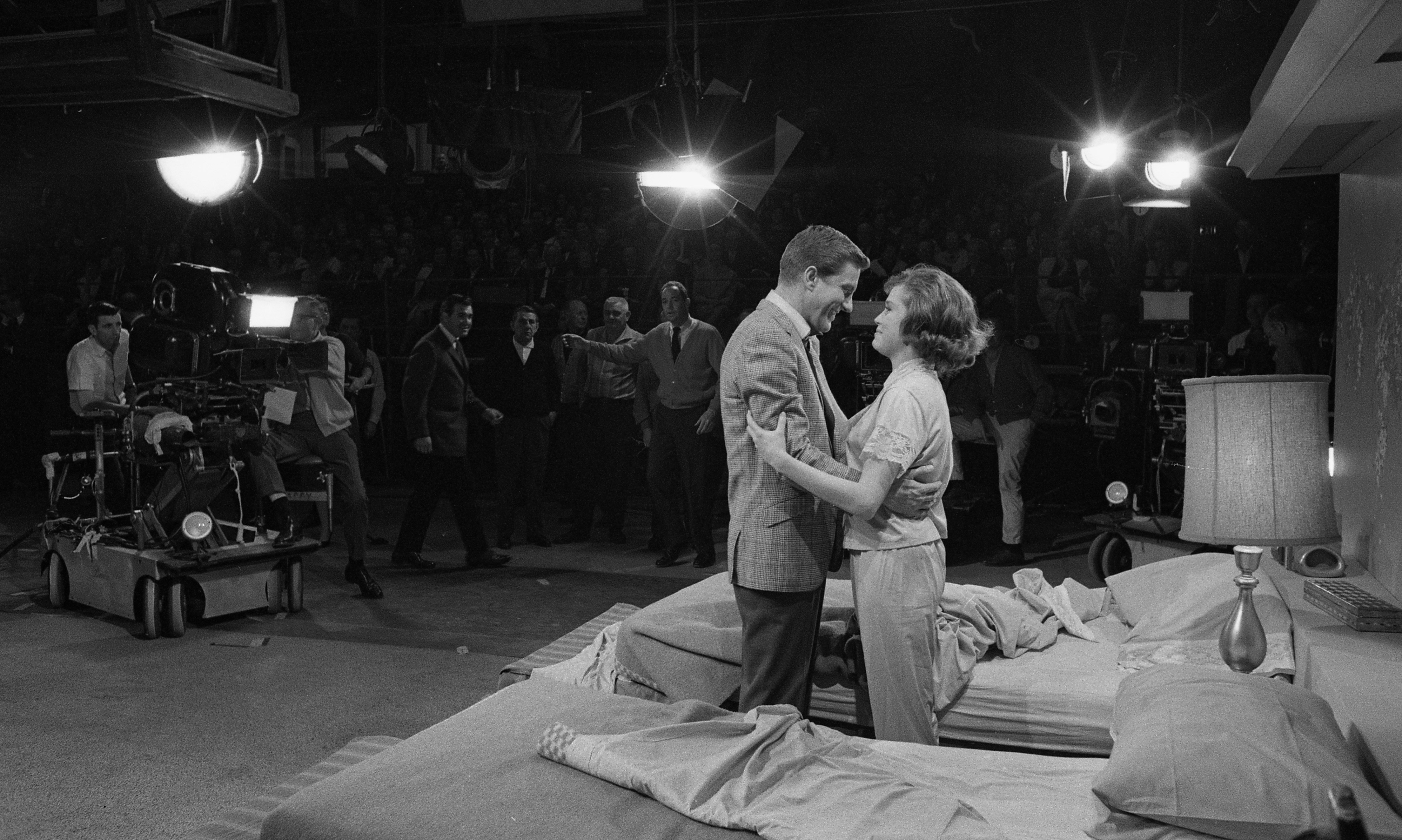 Dick Van Dyke and actress Mary Tyler Moore in rehearsal for The Dick Van Dyke Show stand in front of thier twin beds