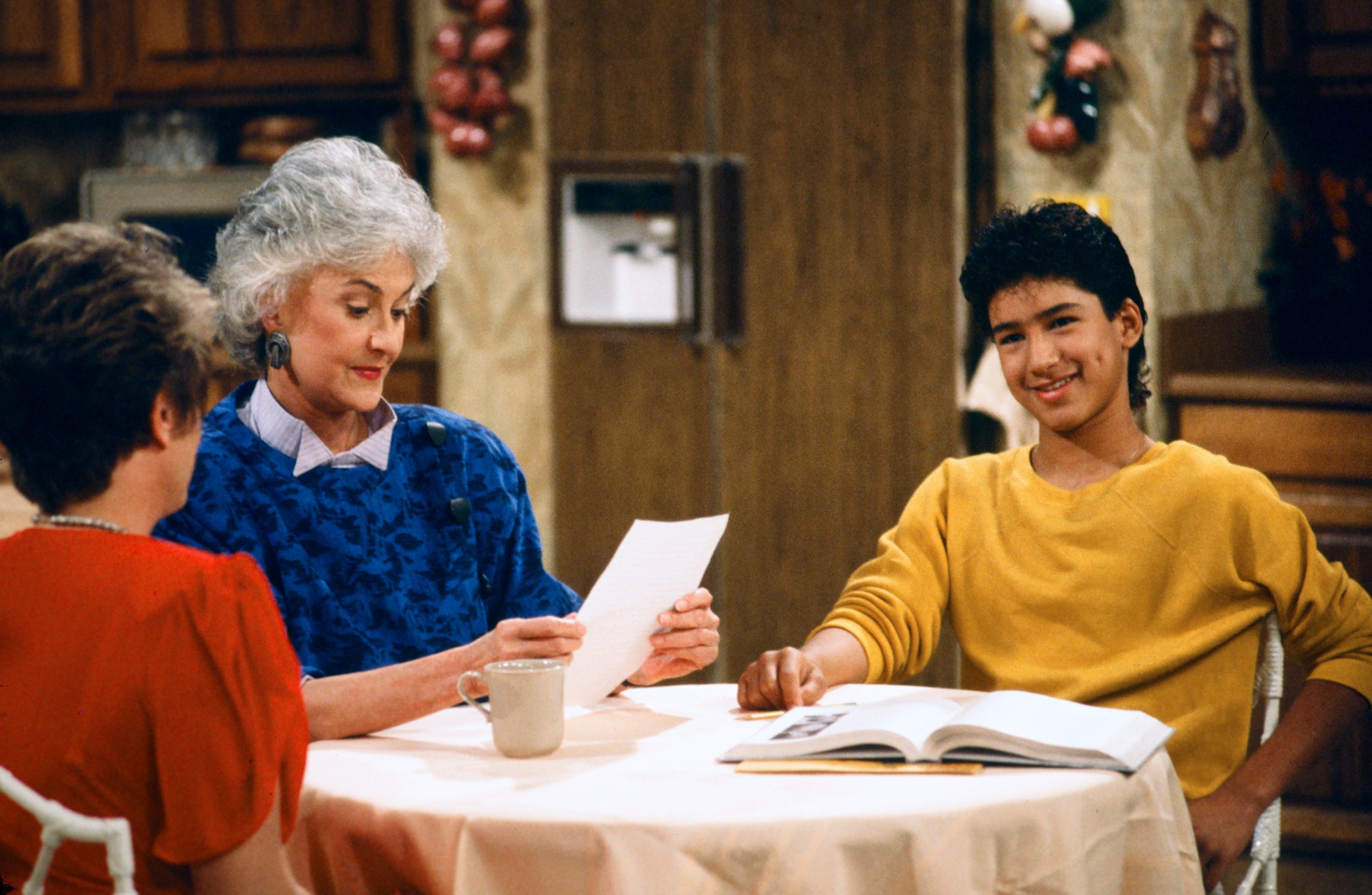 Rue McClanahan as Blanche Devereaux, Bea Arthur as Dorothy Zbornak and Mario Lopez as Mario in the kitchen in an episode of 'The Golden Girls'