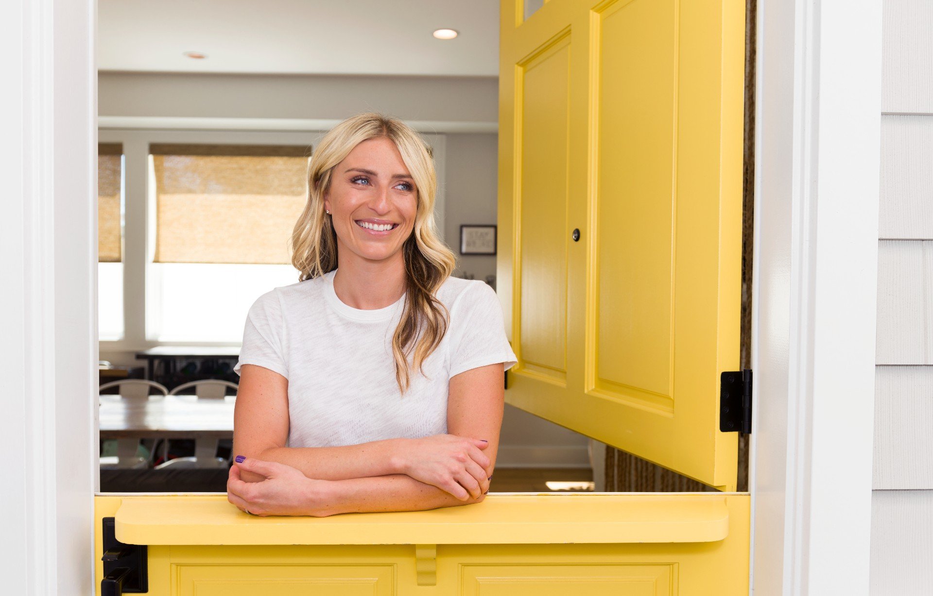 Jasmine Roth stands in a yellow room.