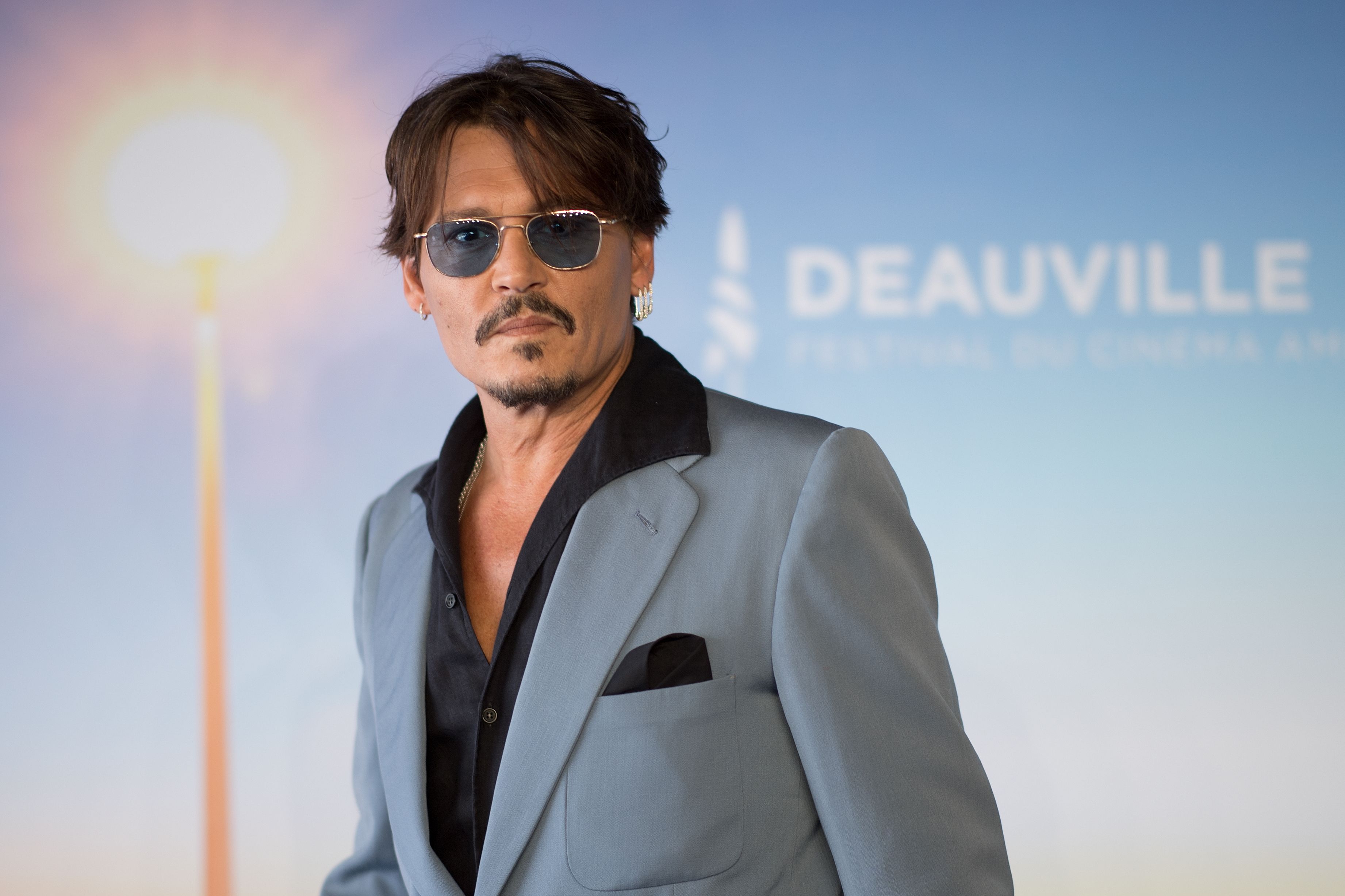 Johnny Depp poses in a suit.