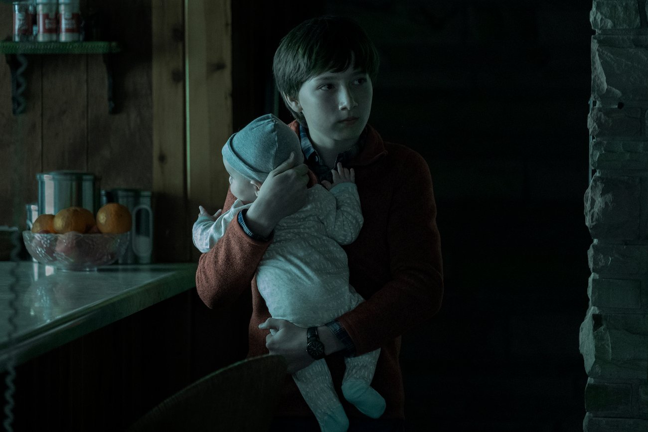 Jonah (Skylar Gaertner) holds baby Zeke in the first season of 'Ozark'