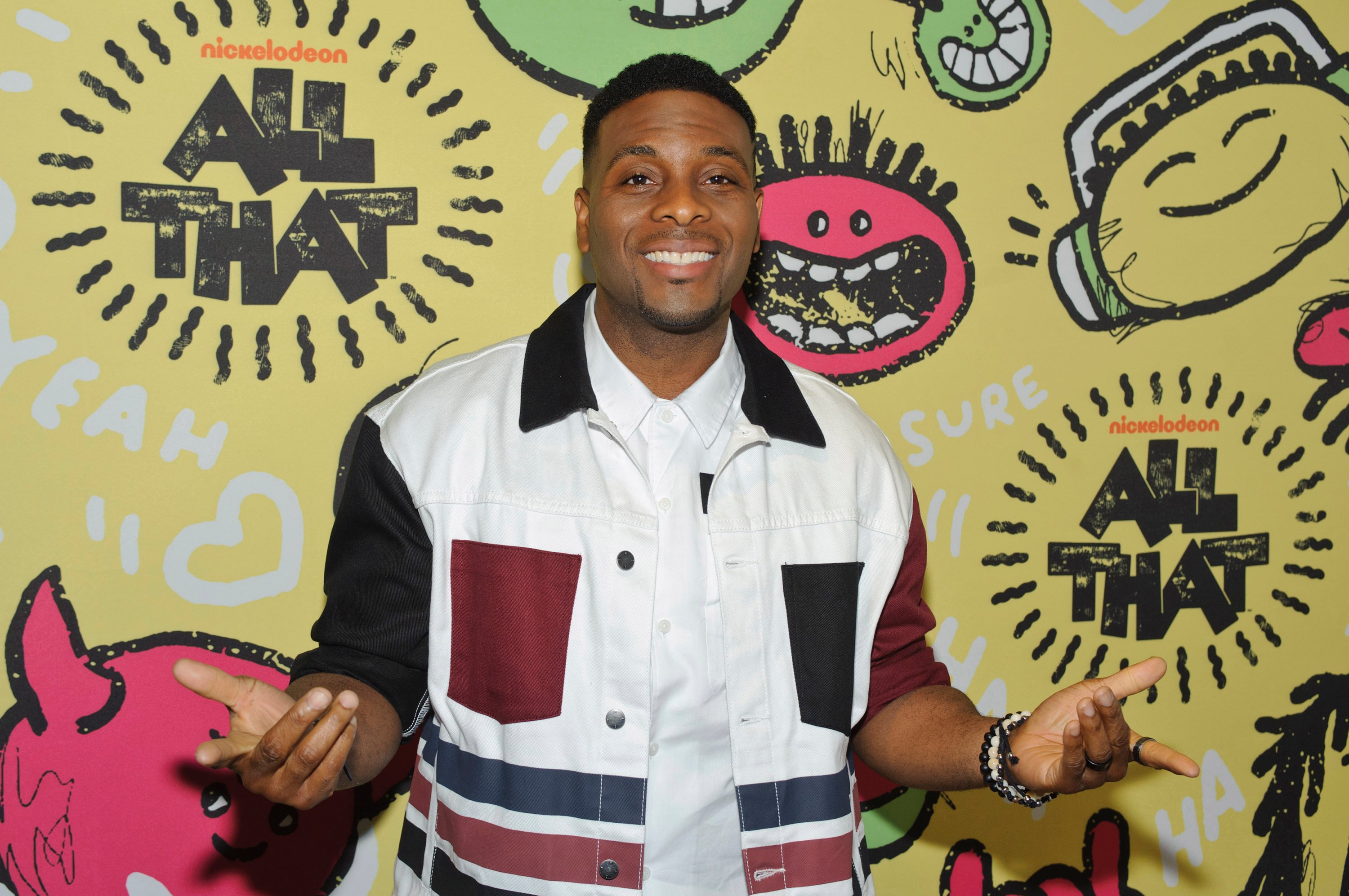 Kel Mitchell, World Vision supporter, poses in front of an 'All That' Step and Repeat
