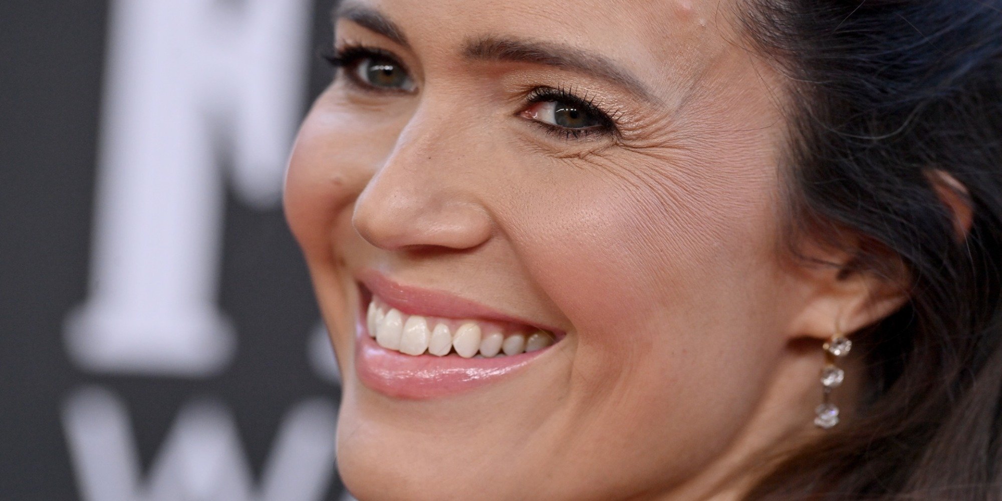 'This Is Us' star Mandy Moore poses on the red carpet in a cream colored gown.