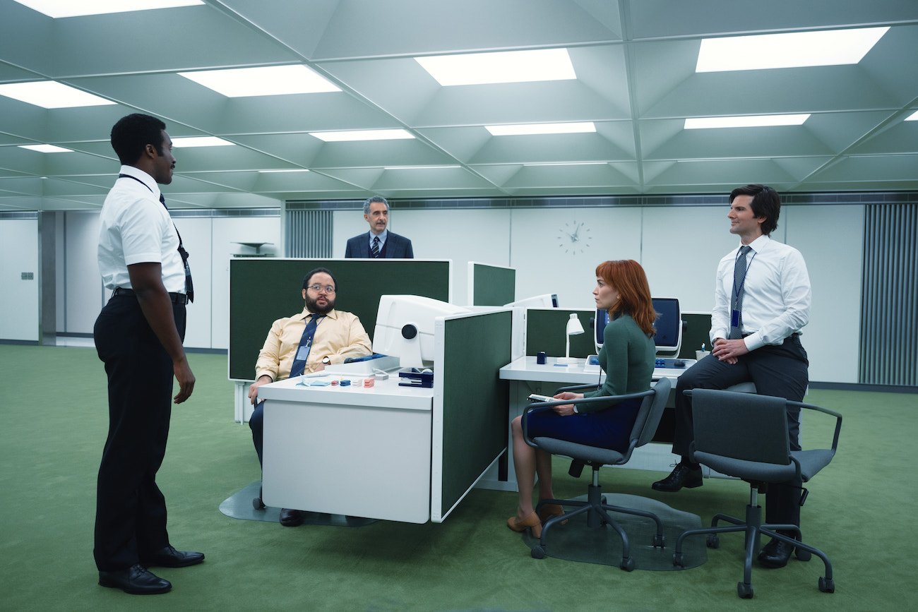 Tramell Tillman, Zach Cherry, John Turturro, Britt Lower and Adam Scott surrounding the MDR desk in 'Severance'