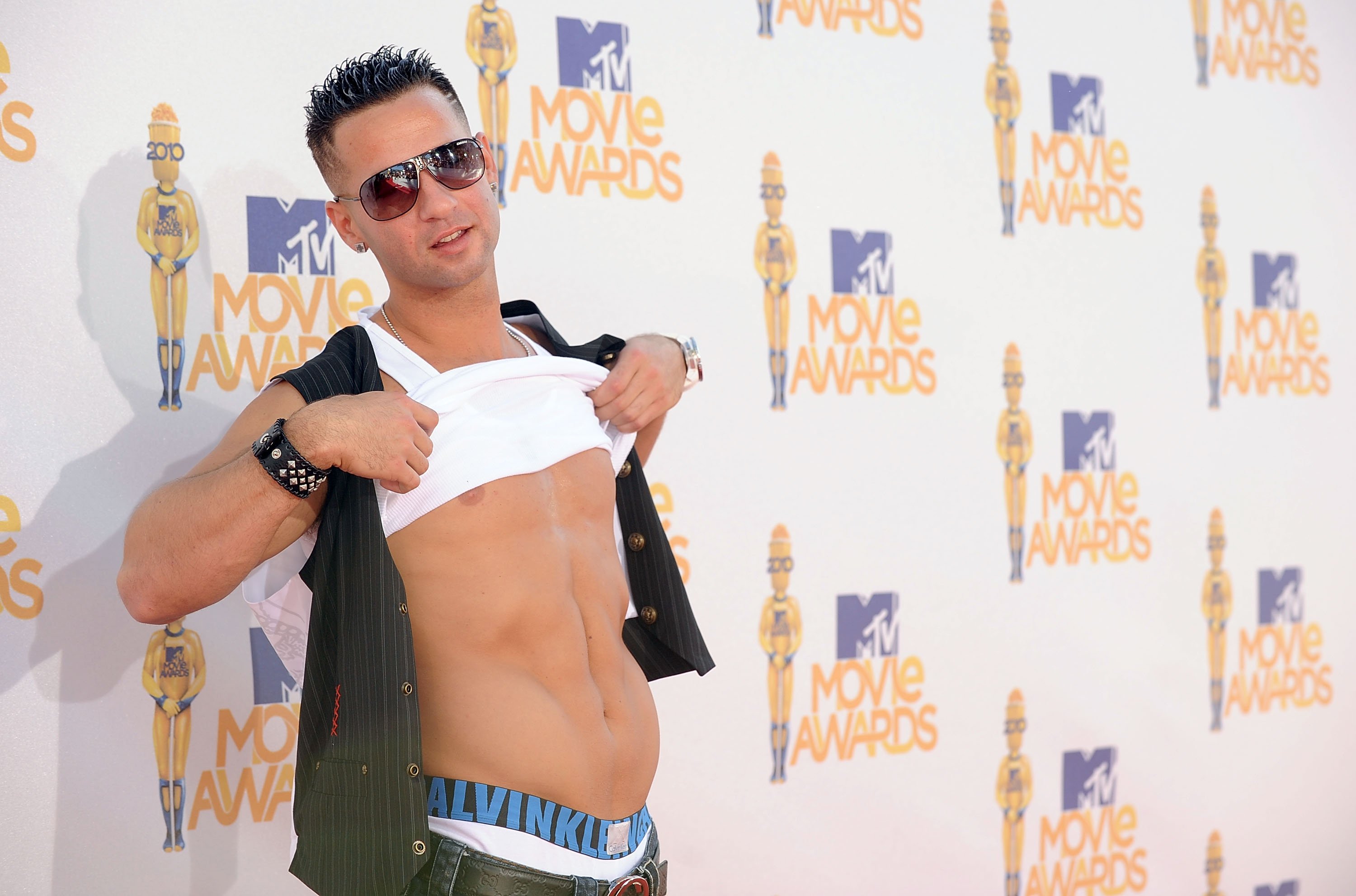 Mike 'The Situation' Sorrentino lifts his shirt to expose his abs, which got the MTV star his nickname